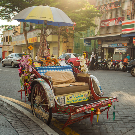 Penang, Malaysia - February 25, 2015: An old traditional trishaw cab along a street in Penang, Malaysia.のeditorial素材