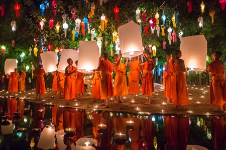 Chiang Mai, Thailand - November 6, 2014: Loy Kratong Festival, Buddhist monk fire candles to the Buddha and floating lamp on November 6, 2014 in Phan Tao Temple, Chiangmai, Thailand.のeditorial素材