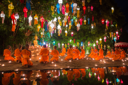 Chiang Mai, Thailand - November 6, 2014: Loy Kratong Festival, Buddhist monk fire candles to the Buddha and floating lamp on November 6, 2014 in Phan Tao Temple, Chiangmai, Thailand.のeditorial素材