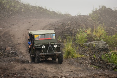 Mount Merapi , Java Indonesia - 15 April 2015 : Jeeps with tourists coming back from a ride around Merapi volcano.のeditorial素材