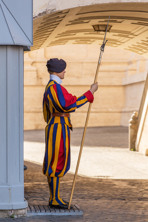 VATICAN CITY, ROME - SEPTEMBER 10:Unidentified Papal Swiss guard standing with a halberd circa September 10, 2015 in Vatican City. Vatican City State is a sovereign city-state within the city of Romeのeditorial素材