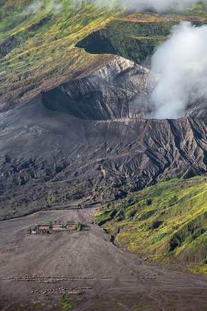 Aerial view of sea of sand inside Bromo Tengger Caldera. Pura Luhur Poten temple and car parking.の写真素材