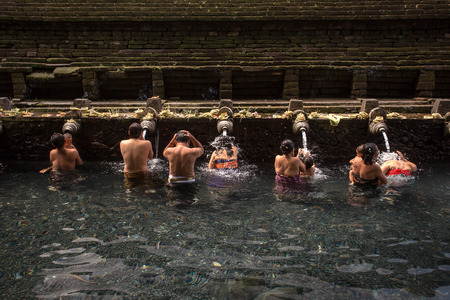Bali, Indonesia - May, 20 2015: Balinese people washing in holy spring water in the sacred pool at Pura Tirta Empul Temple on Bali, Indonesiaのeditorial素材