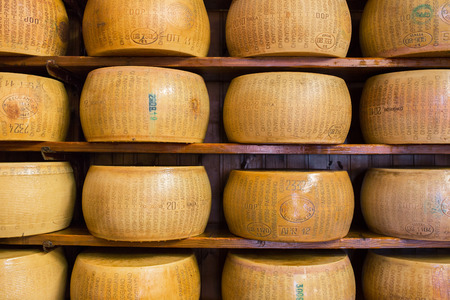 Bologna, Italy - September 19, 2015: Close up of typical Italian hard Parmesan cheese on the shelvesのeditorial素材