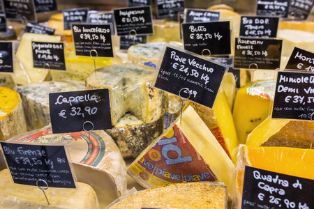 Florence, Italy - September 18, 2015: Various kinds of cheese with price tags on the market in Florence, Italy.のeditorial素材