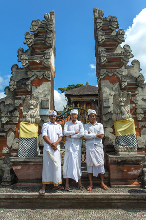 Bali, Indonesia - June 3, 2015: Balinese hindu men in traditional dress posing for photo in front of Pura Ulun Danu temple on a lake Beratan on Bali, Indonesiaのeditorial素材