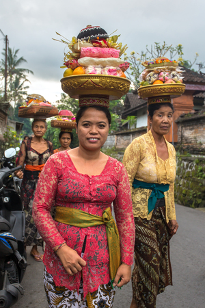 Bali, Indonesia - June 12, 2015:, Women carrying offerings for wedding June 12, 2015 on Bali, Indonesiaのeditorial素材