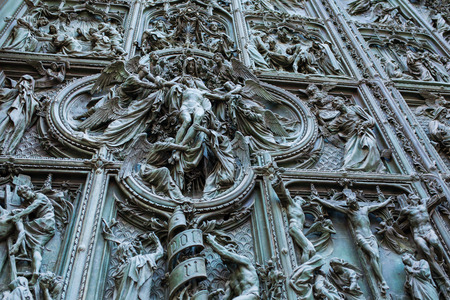 Beautiful carved doors of Il Duomo or Milan Cathedral in Milan, Italyの写真素材