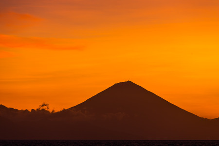 Sunset view on Gunung Batur volcano on Bali from Gili Travangan island, Indonesiaの写真素材