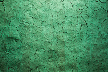 Old texture green cracked wall, the old paint texture is chipping and cracked fall destruction. Grunge wall texture for design. Light from the top.の写真素材