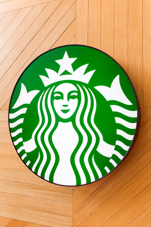 Kota Kinabalu, Malaysia - May 31, 2016: The Starbucks Coffee sign at the wooden background in shopping mall, in Kota Kinabalu, Malaysia. Starbucks is the world's largest coffee house with over 20,000 stores in 61 countries.のeditorial素材