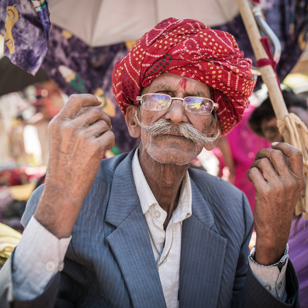 Jodhpur, India - March 9, 2016: Portrait of an unidentified rajasthani man with beautiful red turban and long mustachesのeditorial素材