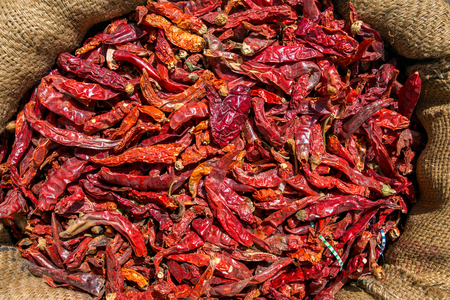 Red dry chillies in canvas bag close-upの写真素材