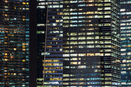 Office buildings at night in Singapore. Background with illuminated modern skyscrapersの写真素材