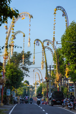 Bali, Indonesia - September 5, 2016: Bali Penjors, decorated bamboo poles along the village street in Bali, Indonesia. Penjors are placed outside Balinese Hindu homes during religious holidays such as Galungan and Kuninganのeditorial素材