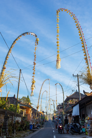 Bali, Indonesia - September 5, 2016: Bali Penjors, decorated bamboo poles along the village street in Bali, Indonesia. Penjors are placed outside Balinese Hindu homes during religious holidays such as Galungan and Kuninganのeditorial素材