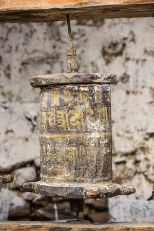Manang, Nepal - May 6, 2016: Buddhist prayer mani wall with prayer wheels in nepalese village on the Annapurna circuit trekking route, Nepalの写真素材