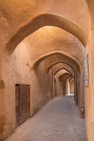 Old passage with traditional clay arches in the city of Yazd, Iran.の写真素材