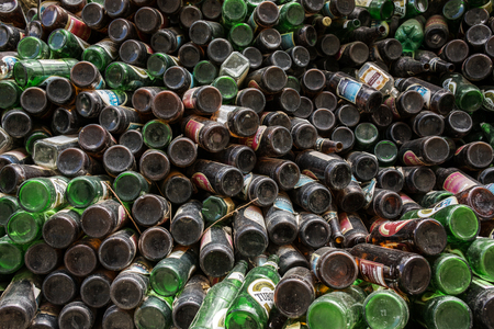 Muktinath, Nepal - May 12, 2016: Heap of beer bottles stored outdoor for sale for recycling.のeditorial素材