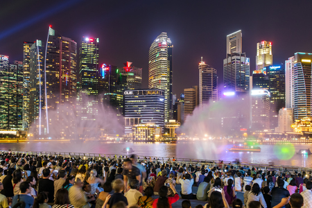 Singapore - June 25, 2016 : People are watching water show in front of The Shopper of Marina Bay.のeditorial素材