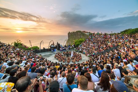 Bali, Indonesia - September 19: Tourists watch traditional Balinese Kecak Dance at Uluwatu Temple on Bali, Indonesia. Kecak (also known as Ramayana Monkey Chant) is very popular cultural show on Bali.のeditorial素材
