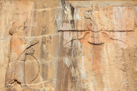 Faravahar - relief of winged sun symbol of Zoroastrianism in ruined Persepolis cityの写真素材