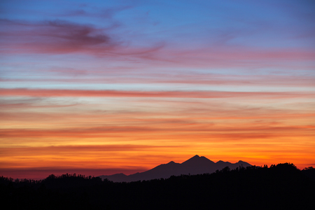 Beautiful sunset sky over the mountains in Bali, Indonesiaの写真素材