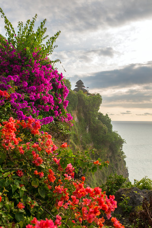 View of Uluwatu temple with a beautiful flowers in front, Bali, Indonesia.の写真素材