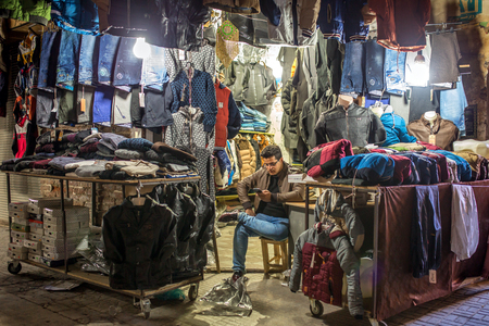 Urmia, Iran - December 2, 2015: Unidentified iranian man sell clothes on the street of Urmia, Iranのeditorial素材