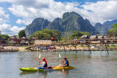 Vang Vieng, Laos - January 19, 2017: Unidentified tourists are rowing kayak boats in Nam Song River in Vang Vieng, Laosのeditorial素材