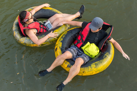 Vang Vieng, Laos - January 19, 2017: Tourist enjoy tubing in Song River at Vang Viang, Laos.のeditorial素材