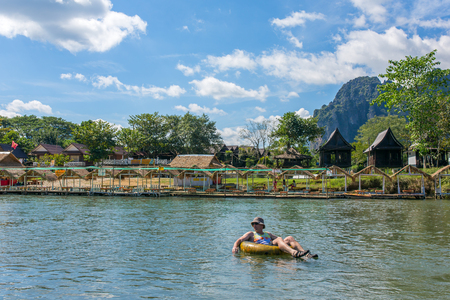 Vang Vieng, Laos - January 19, 2017: Unidentified tourist enjoy tubing in Song River in Vang Viang village, Laos.のeditorial素材