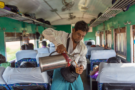 Yangon, Myanmar - October 15, 2016: Unidentified burmese man selling tea in the train in Myanmar.のeditorial素材