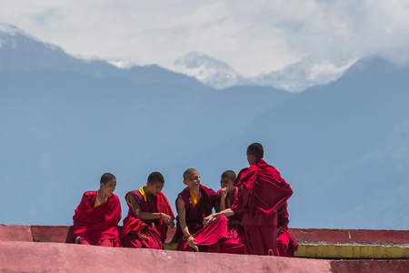 Sikkim, India - May 2, 2017: Tibetan monks rest at upper level of Rumtek Monastery near Gangtok with Himalayas mountains on background, Sikkim, Indiaのeditorial素材