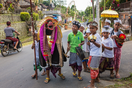 Bali, Indonesia - September 7, 2016: Balinese kids playing Barong walking on the streets of Ubud in Bali, Indonesia.のeditorial素材