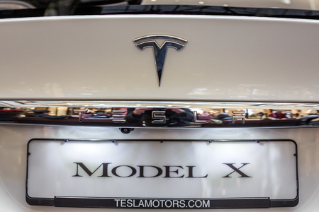 Berlin, Germany - December 6, 2017: Tesla logo on a Tesla car. Tesla, Inc. is an American company that specializes in electric automotives, energy storage and solar panel manufacturing.のeditorial素材