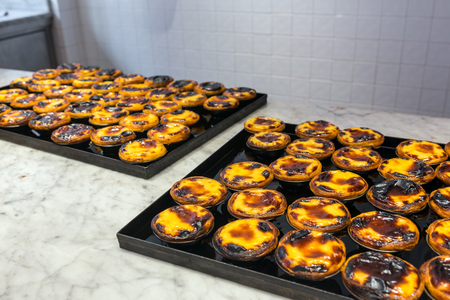Traditional portuguese pastry - pastel de nata in a bakery in Porto, Portugalの写真素材