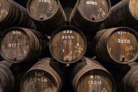 Row of wooden porto wine barrels in wine cellar Porto, Portugal.の写真素材
