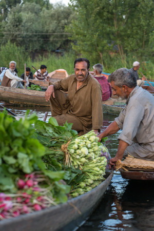 Srinagar, India - June 16, 2017: Unidentified vegetable sellers taking their produce to the floating market  early in the morning on Dal Lake in Srinagar, Kashmir.のeditorial素材