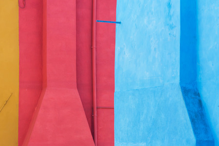 Close up view of exterior wall of a colorful painted houses on Burano island, Venice, Italy. That island is famous for beautiful mixed colored houses.の写真素材