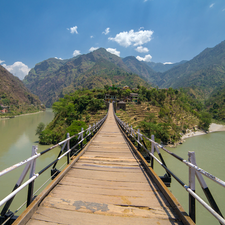 Beautiful wooden bridge over the Beas river in Aut Village in Kullu valley, Himachal Pradesh, Indiaの写真素材