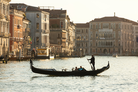 Venice, Italy - March 22, 2018: Venetian gondolier riding tourists on gondola at Grand Canal in Venice.のeditorial素材