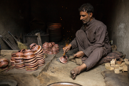 Srinagar, India - June 15, 2017: Unidentified  Kashmiri man working in blacksmith in Srinagar, Indiaのeditorial素材