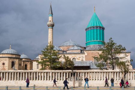 Unidentified turkish people walk near the Mevlana museum mosque in Konya, Turkey.のeditorial素材