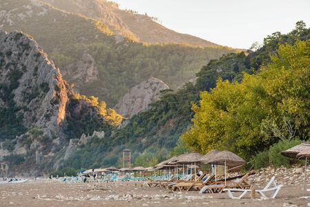 Beach umbrellas and sunbeds on the Cirali beach in Turkeyの写真素材