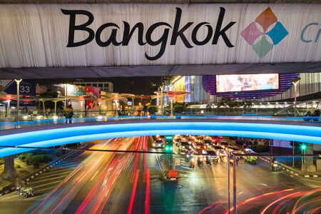 Bangkok sign at the BTS metro bridge and busy street at night at downtown city centerのeditorial素材