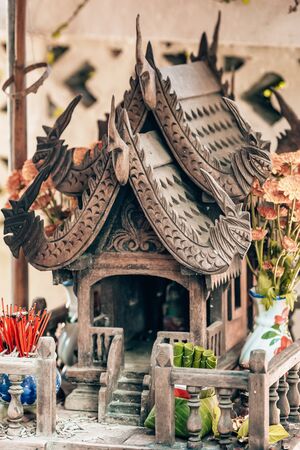 Wooden carved spirit house in Thailandの写真素材