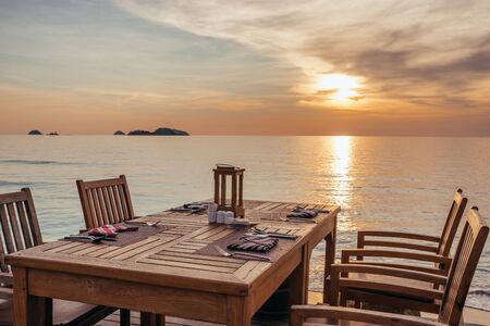 Outdoor cafe on the beach during sunset on Koh Chang island, Thailand.の写真素材