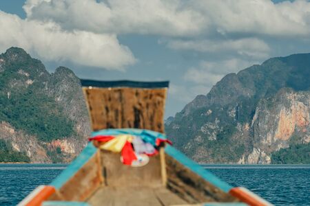 Wooden traditional thai longtail boat on Cheow Lan lake in Khao Sok National Parkの写真素材