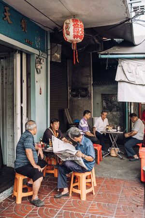 Unidentified chinese men are sitting in traditional local cafe in Chinatown area in Bangkok, Thailand.のeditorial素材